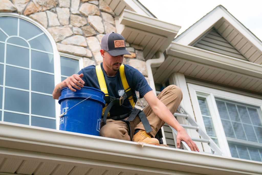 gutter cleaning services being provided by a technician