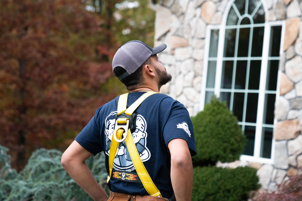 gutter contractor services technician evaluating a gutter system